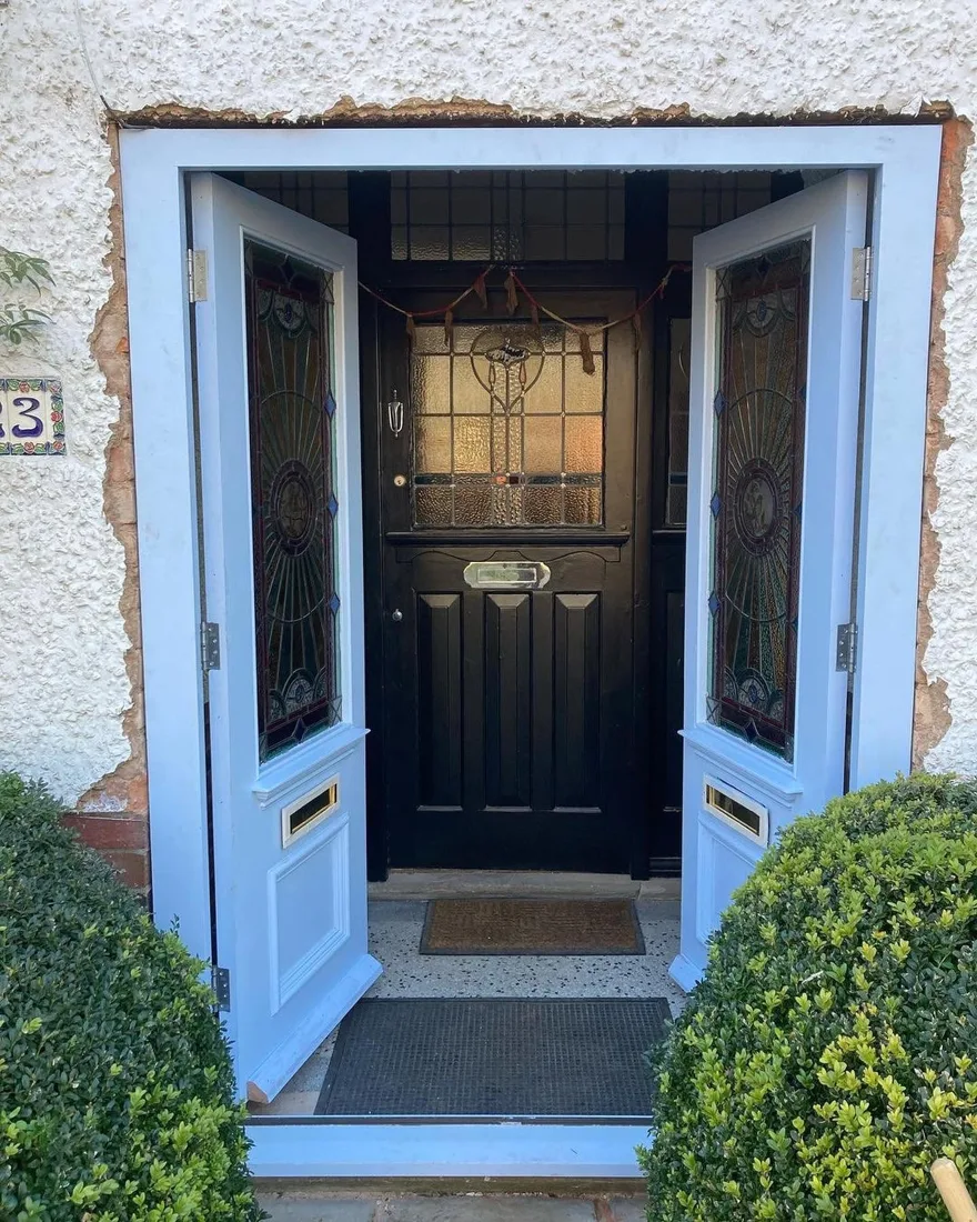 Period front door fitting with stained glass panels